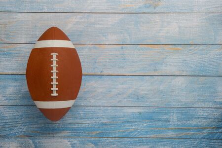 American football ball on wooden backgroundの写真素材