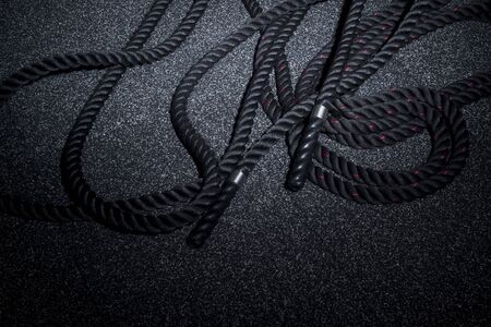 Close up of black battle rope on a gray backgound. Sport and fitness equipment. Functional trainingの写真素材
