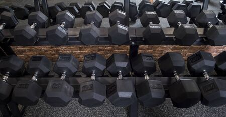 Close up many metal dumbbells on rack in sport fitness centerの写真素材