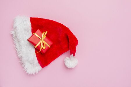 Gift box with santa hat on pink backgroundの写真素材