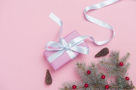 Christmas gift box with decoration on pink background. Top viewの写真素材