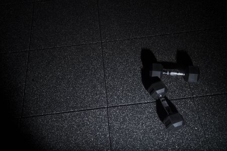 Fitness or bodybuilding concept background. Dumbbell exercise weights on the floorの写真素材