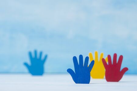 Colorfull puzzles hands on blue background. World Autism Awareness Day Conceptの写真素材