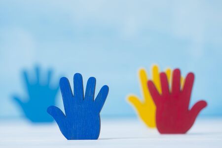 Colorfull puzzles hands on blue background. World Autism Awareness Day Conceptの写真素材