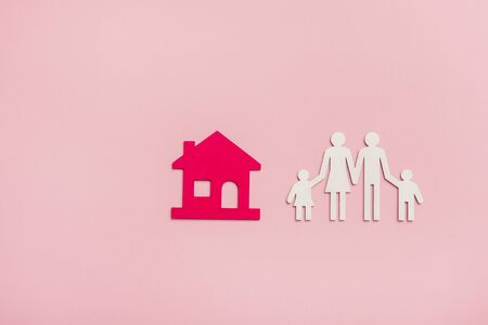 Family figures with house on pink backgroundの写真素材