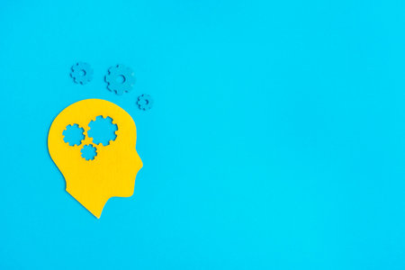 Brain works concept. Thinking, creativity concept of the human head with gears on blue background