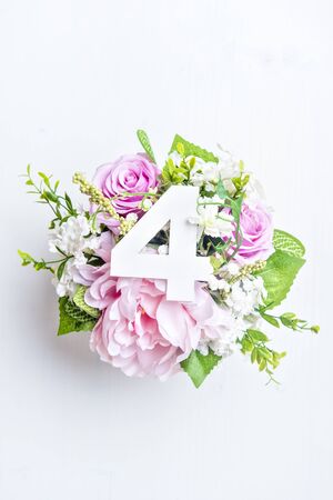 Layout with colorful flowers, leaves and number four. Flat lay. Top view.の写真素材
