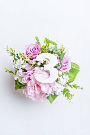 Layout with colorful flowers, leaves and number three. Flat lay. Top view.の写真素材