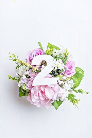 Layout with colorful flowers, leaves and number two. Flat lay. Top view.の写真素材
