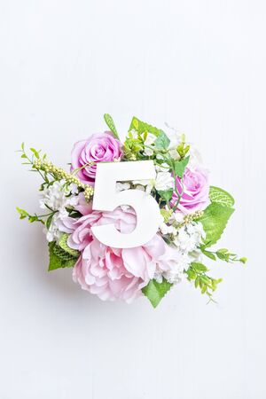 Layout with colorful flowers, leaves and number five. Flat lay. Top view.の写真素材