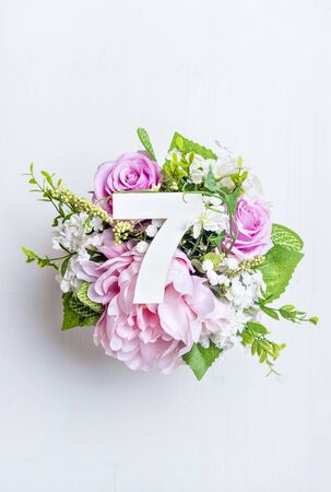 Layout with colorful flowers, leaves and number seven. Flat lay. Top view.の写真素材