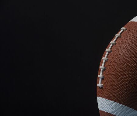 American football ball close up on black background.の写真素材