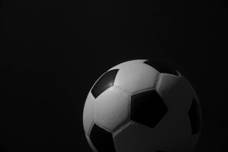 Closeup of football ball on black backgroundの写真素材