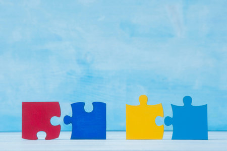 Colorfull puzzles piece on blue background. World Autism Awareness Day Concept