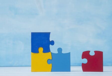 Colorfull puzzles piece on blue background. World Autism Awareness Day Conceptの写真素材