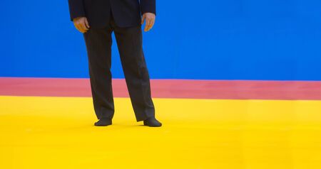 Sports referee on a yellow wrestling carpet in the gymの写真素材