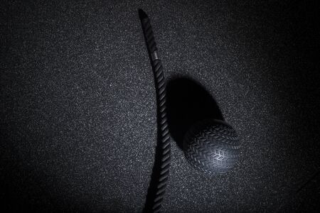 Black rope and a medicine ball. Sports equipment for workout with free weight. Functional trainingの写真素材