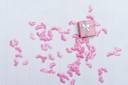 Gift box with hearts on a white wooden background. Valentine`s day.の写真素材