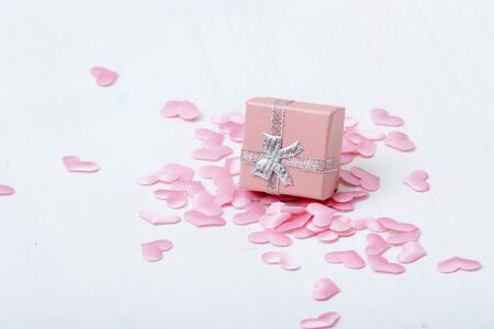 Gift box with hearts on a white wooden background. Valentine`s day.の写真素材