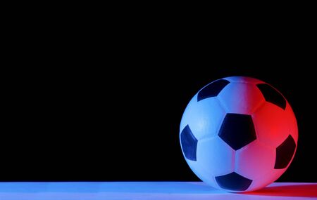 Soccer ball isolated on black background. Blue neon Banner Art conceptの写真素材