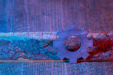 Gears on the wooden background. Machine part. Neon color.の写真素材