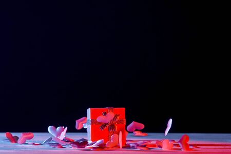 Gift box with hearts on a pink background. Valentine`s day. blue neon banner Art conceptの写真素材