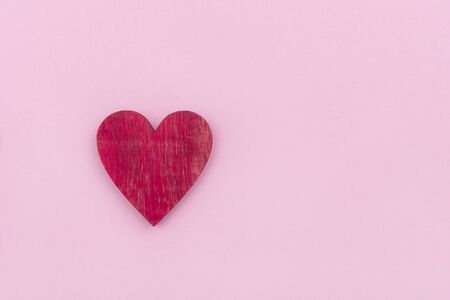 Wooden heart over pink background. Valentine's Day Backgroundの写真素材