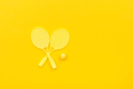 Tennis racket and ball sports on yellow background.の写真素材