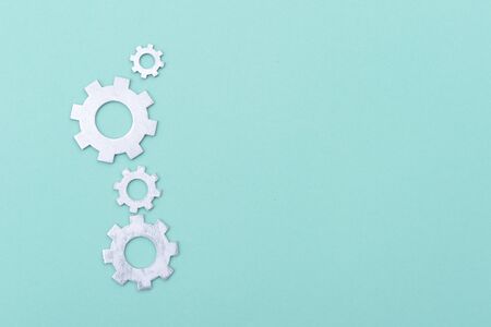 Working system of cogwheels, teamwork, flat lay, bright green backgroundの写真素材