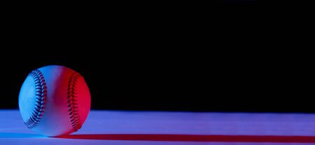 Baseball ball isolated on black background. Blue neon Banner Art conceptの写真素材