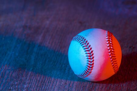 Baseball ball on wooden background. Blue neon Banner Art conceptの写真素材