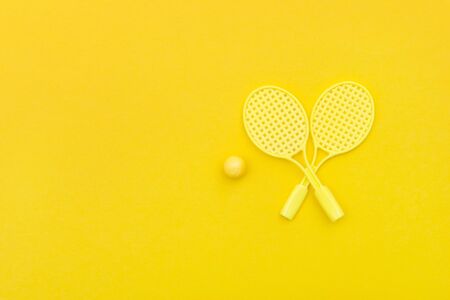 Tennis racket and ball sports on yellow background.の写真素材