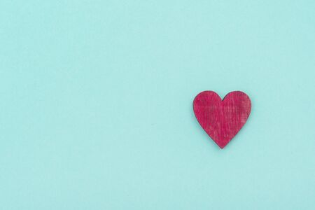 Wooden heart over pastel green background. Valentine's Day Backgroundの写真素材