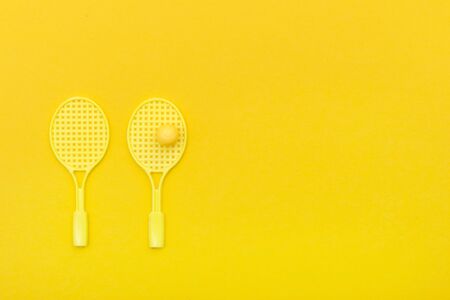 Tennis racket and ball sports on yellow background.の写真素材