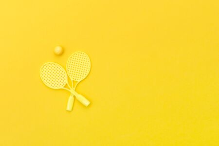 Tennis racket and ball sports on yellow background.の写真素材
