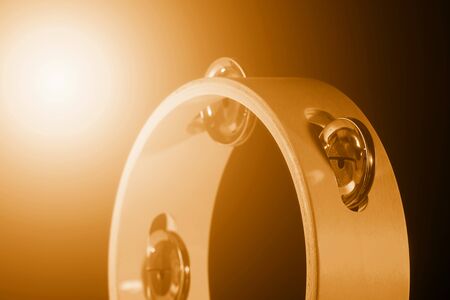 Tambourine isolated on black background. Yellow filter. Single classical music instrument. の写真素材