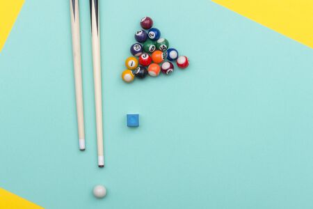 Pool Billiard equipments on a green and yellow background.の写真素材