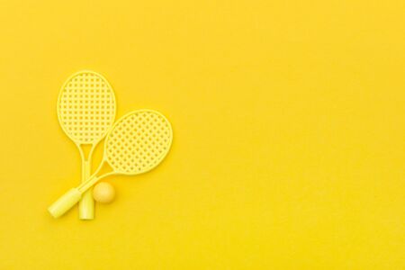 Tennis racket and ball sports on yellow background.の写真素材