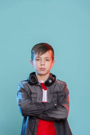 Kid listening music headphones. Music beat concept. Entertainment and fun. Child or teen enjoy music.の写真素材