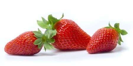 Three strawberries with strawberry leaf on white background.の写真素材