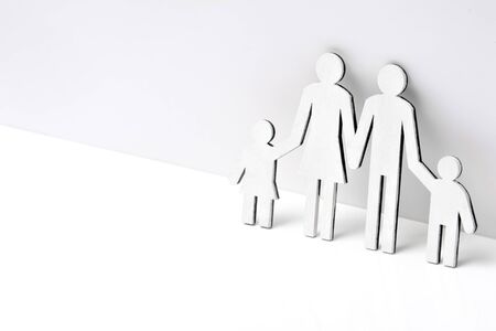 Happy family of wooden figures on a white backgroundの写真素材