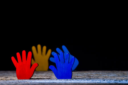 Colorfull puzzles hands on black background. World Autism Awareness Day Conceptの写真素材