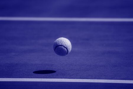 Close-Up Of A Shadow And A Tennis Ball. Individual sport. Blue filterの写真素材