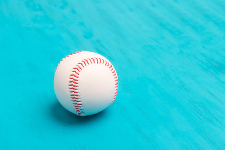 Baseball ball on blue wooden background. Team sport concept