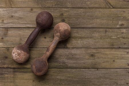 Old Dumbbells On Wooden Surfaceの写真素材