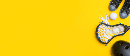 Close-Up Of Lacrosse Equipment On Yellow Background. Team sport concept.