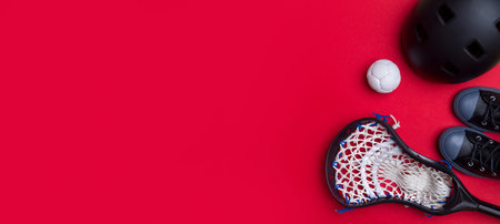 Close-Up Of Lacrosse Equipment On Red Background. Team sport concept.
