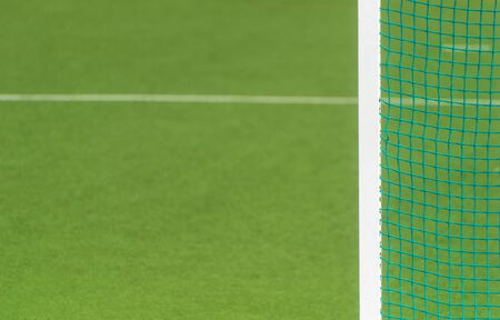 Hockey field, football, lacrosse  net background over green grass and blurry stadium. Sport team conceptの写真素材