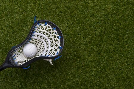 Abstract view of a lacrosse stick scooping up a ballの写真素材