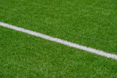 Green synthetic grass sports field with white line shot from above. Soccer, rugby, football, baseball sport conceptの写真素材